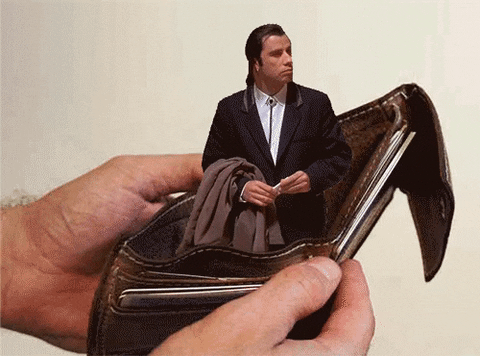 Gif shows Vincent Vega from Pulp Fiction standing in an open wallet, and looking around.