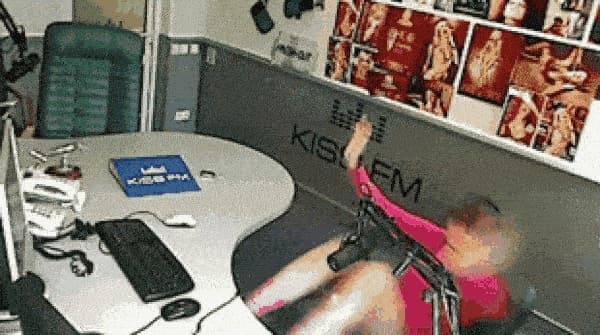 Image shows a KISS FM DJ falling off chair.