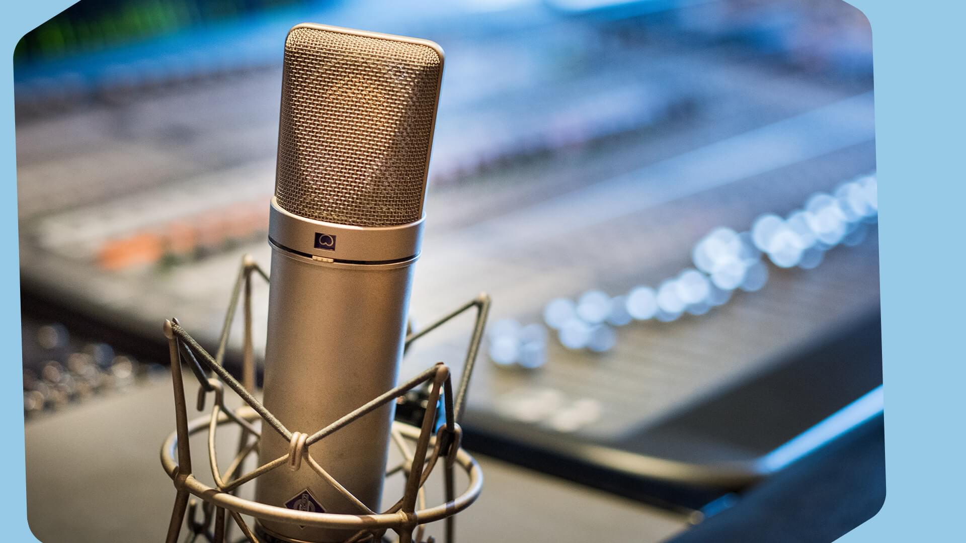 The image is a silver microphone in the corner against a mixer backdrop. The borders of this image are light blue.