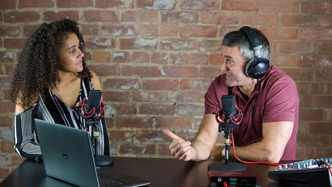 Image shows two radio presenters chatting.