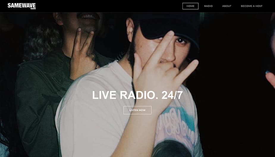 This is a screenshot of the Samewave homepage. In the middle of the image it reads Live Radio 24/7. In the back is a film processed image of a boy wearing a black cap. He is doing a rock signal with his hands over his face. In the background we see a peace sign and a smile of another boy, but it cuts off the top of his face.