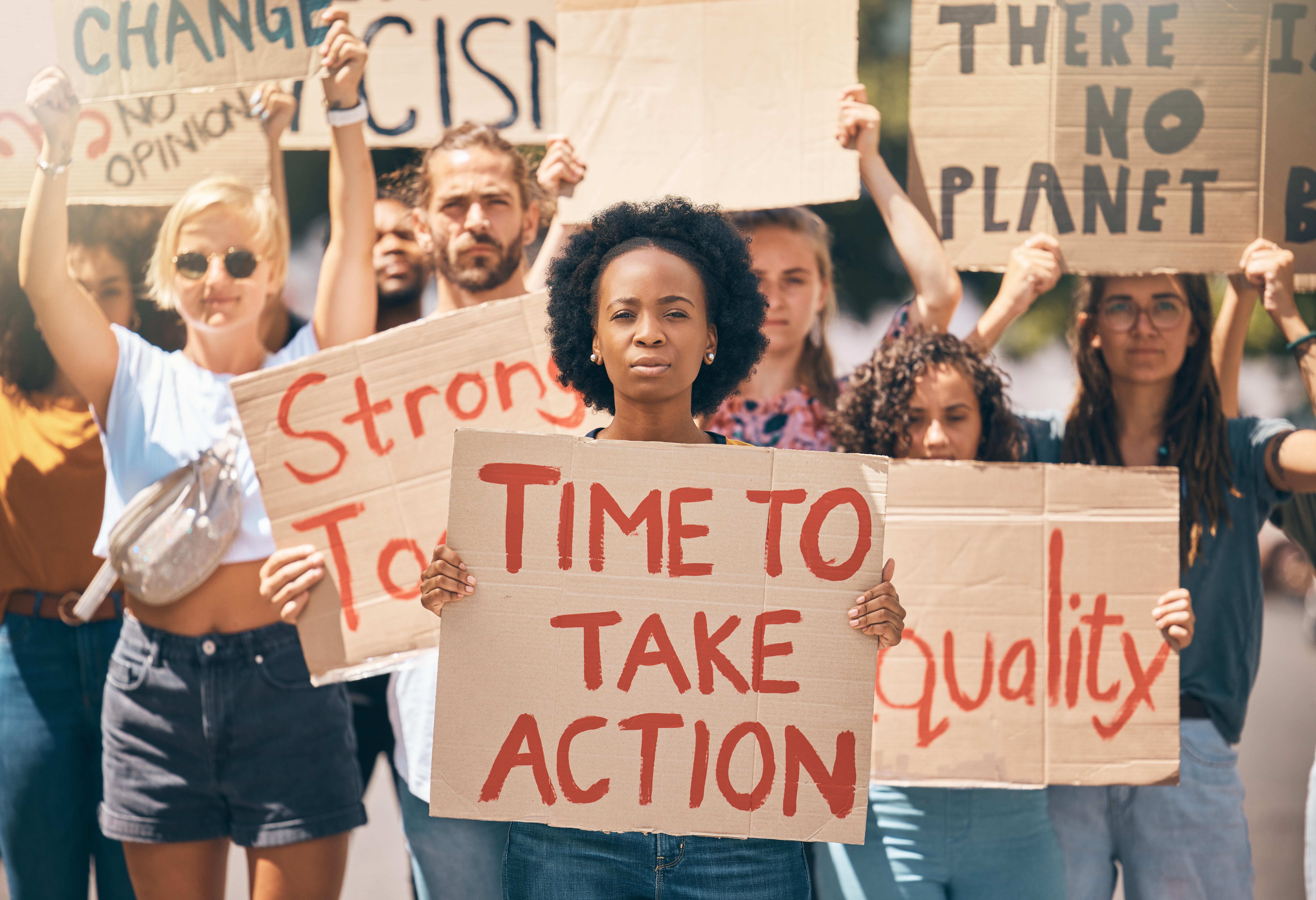 Group, protest and portrait in street, poster or climate change with march, walking or together for change. People, diversity or action in activism, equality or empowerment for racism, lgbt and earth.