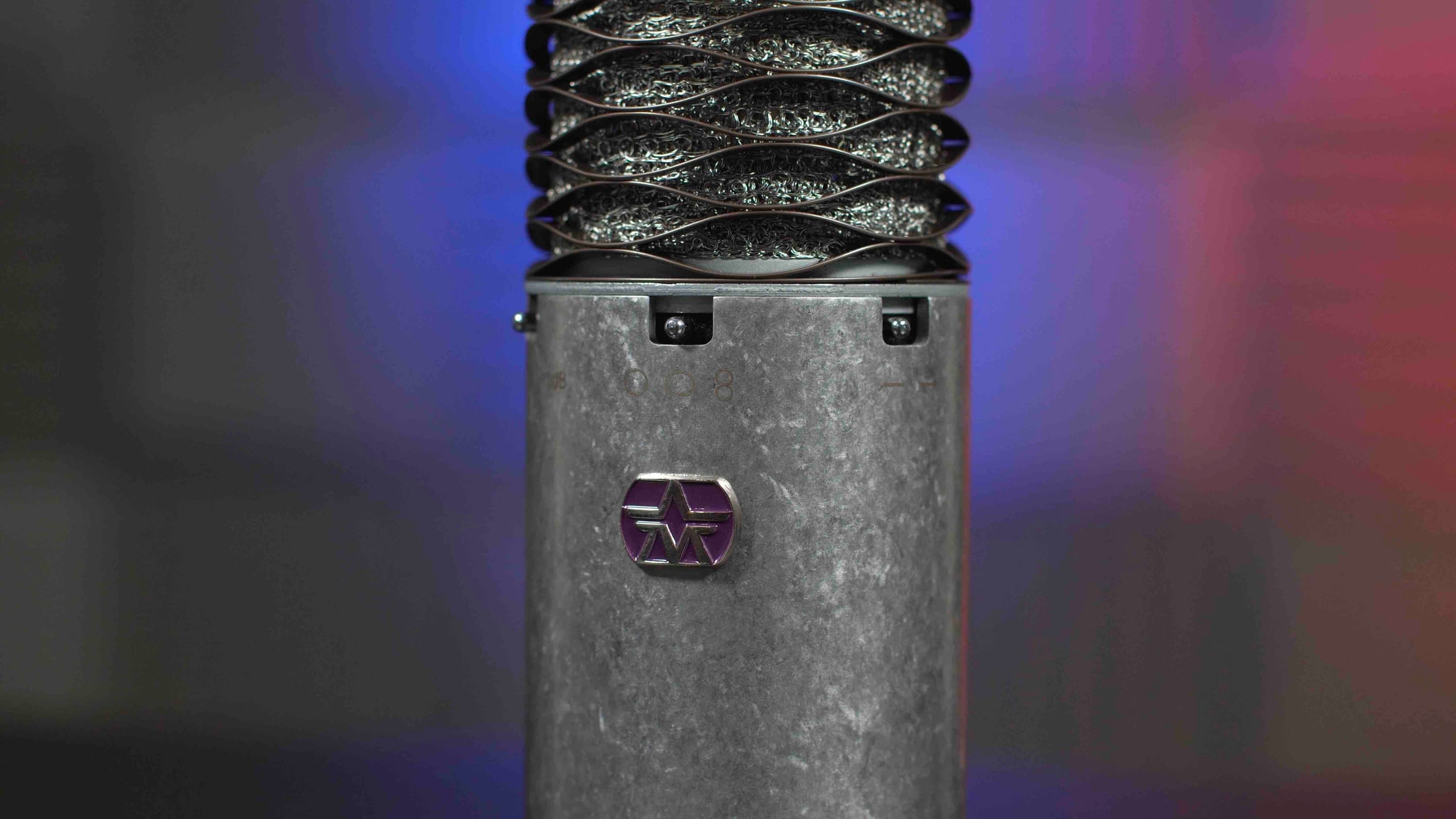 Image shows a close up of the Aston Spirit Mic, a silver metal microphone.