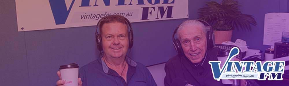 Image shows two older male Vintage FM presenters looking at the camera and smiling, and there is a Vintage FM logo overlaid the image in the bottom right-hand corner.