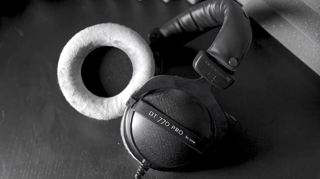 This is a stock image of the black Beyerdynamic DT770 Pro headphones on a plain black backdrop.