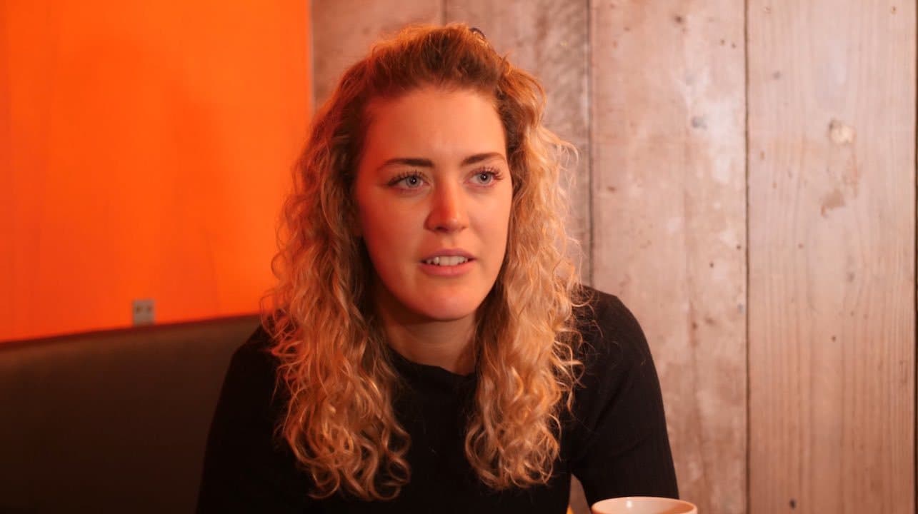 Image shows Boogaloo Radio director, Jennifer Crothers, a woman with blonde curly hair, sitting in the Boogaloo pub.