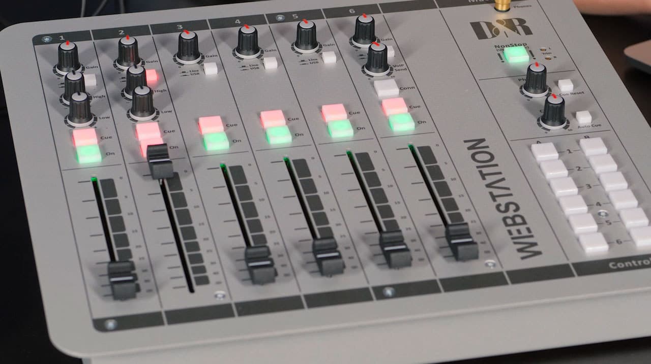 Image shows the D&R WEBSTATION professional USB mixer, turned on and lit up.