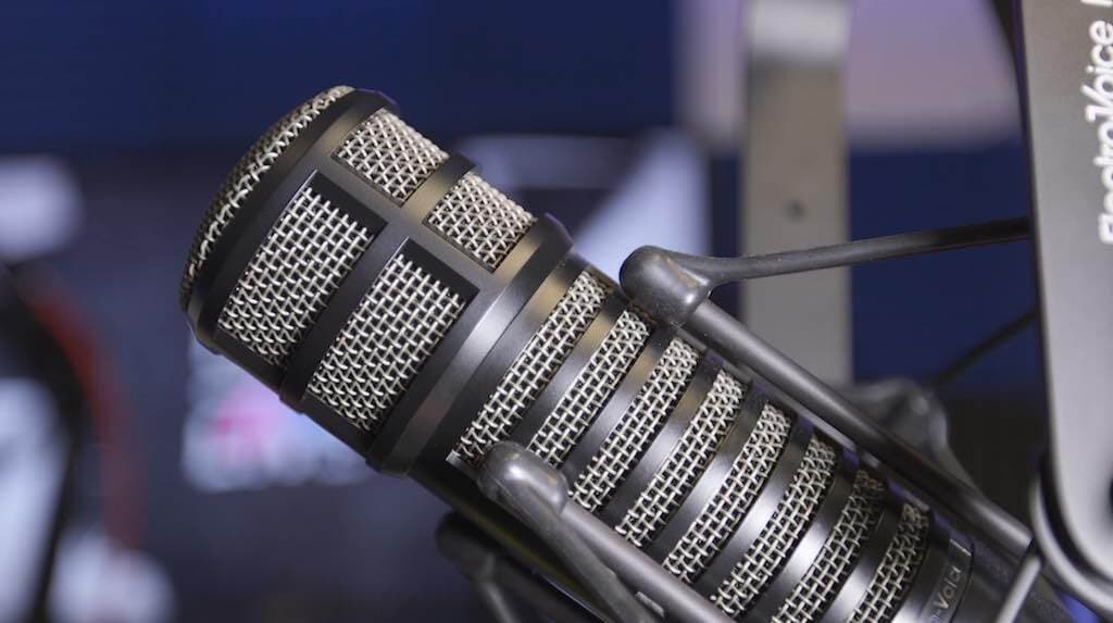 This is a grey and black Electro Voice RE320 Pro microphone against a blue backdrop.