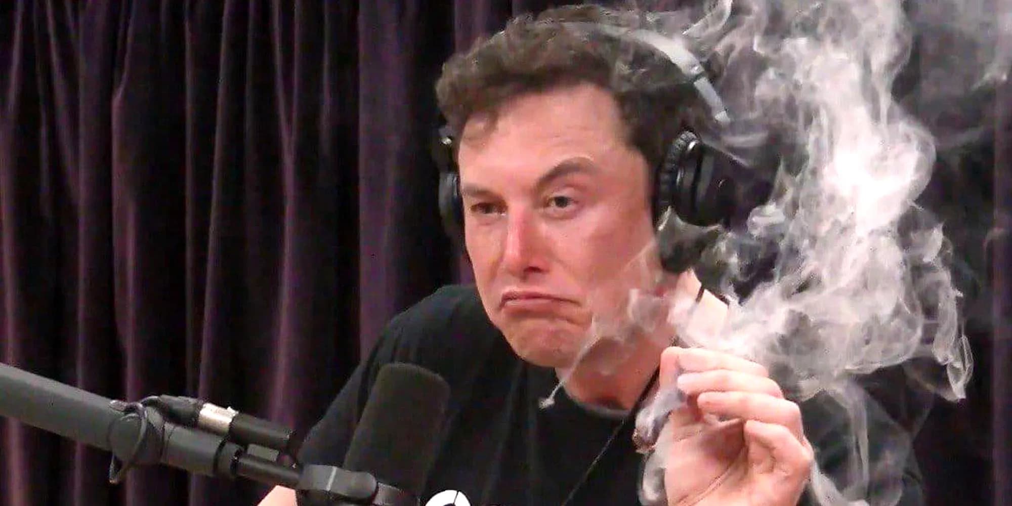 Image shows Elon Musk on the Joe Rogen Experience, smoking a blunt.