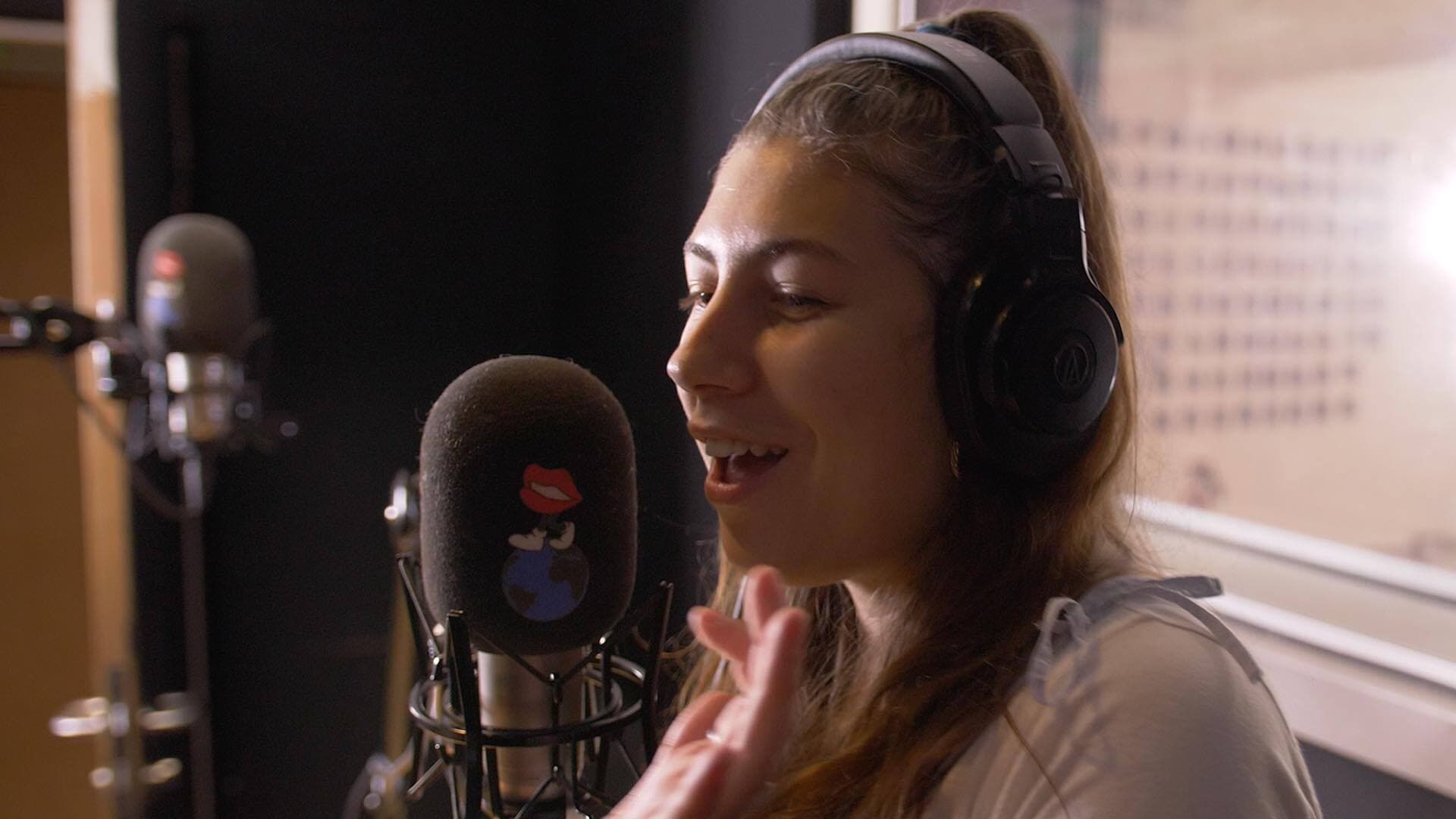 Image shows Foundation FM co-founder Frankie Wells behind the mic.