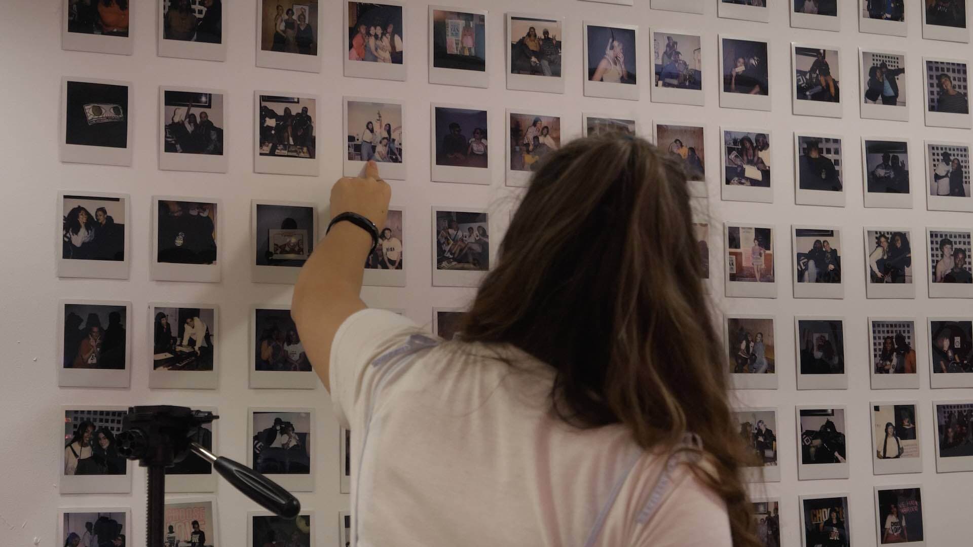 Image shows a wall in the Foundation FM radio studio which has polaroid photos of all their radio hosts.