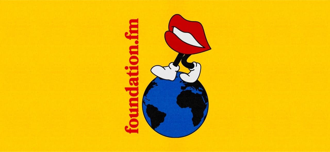 Image shows the Foundation FM logo: An animated pair of lips with legs, walking across the globe against a yellow background. There is red, vertical font that reads: "foundation.fm".