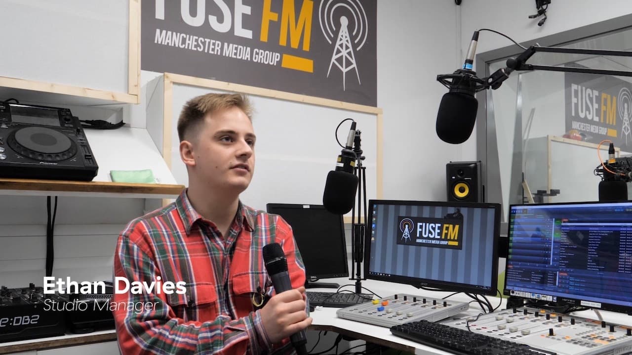 Image shows Fuse FM station manager Ethan Davies inside the Fuse FM radio booth.