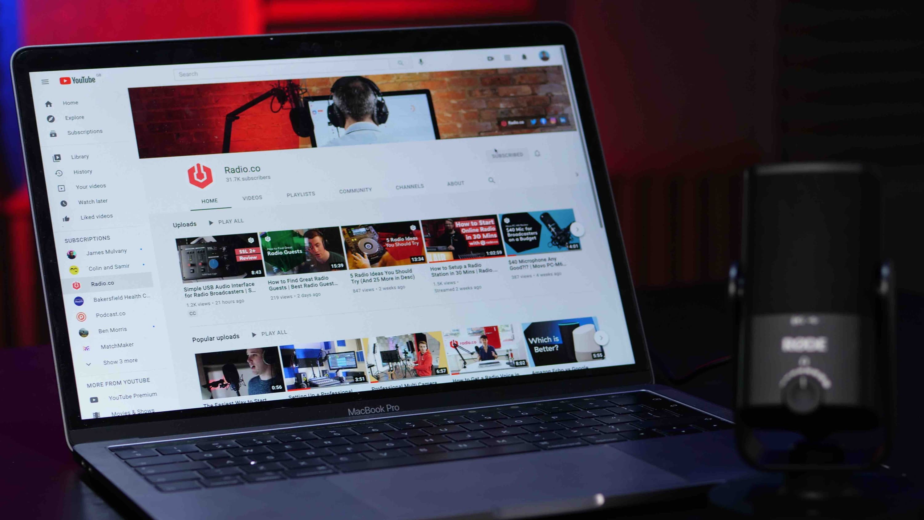 Image shows a laptop with the Radio.co YouTube channel on the screen.