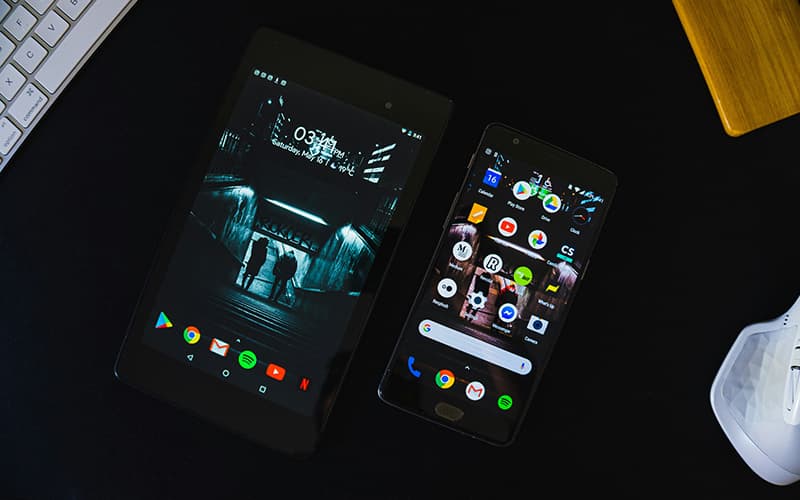 Image shows an Android tablet and smartphone, side by side on a desk.
