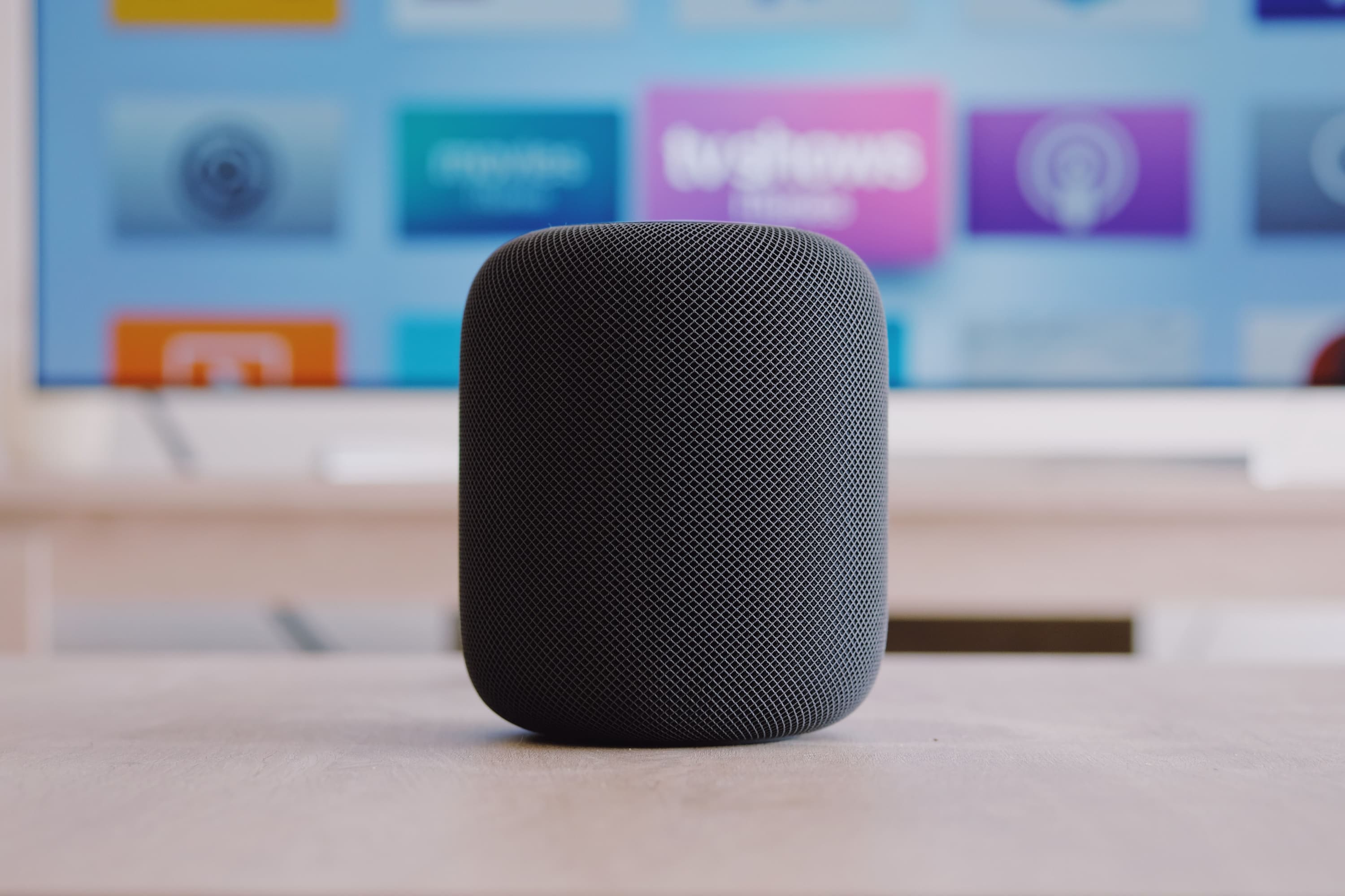 An echo dot speaker on a table.