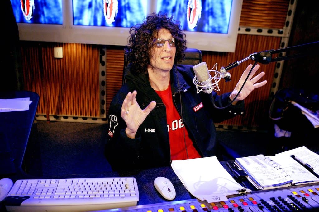 A photo of Howard Stern in a radio studio, presenting his radio show.
