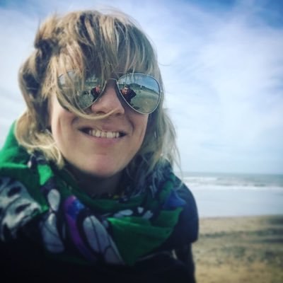 Image shows the a selfie of presenter coach Kate Cocker, taken on a windy beach.