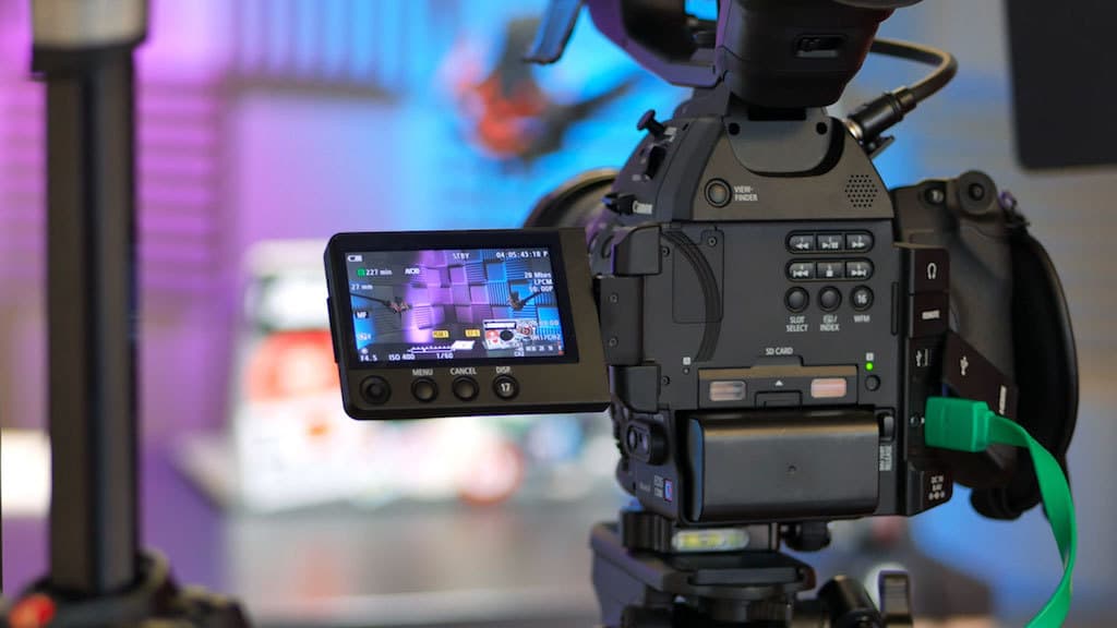 Image shows a video camera recording the livestream.