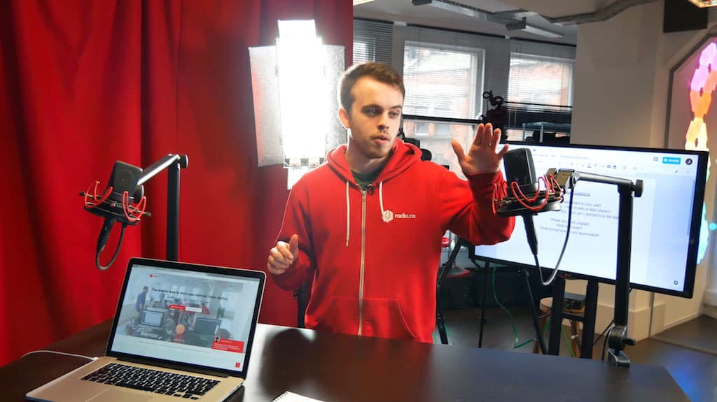 Image shows a man setting up a livestream.