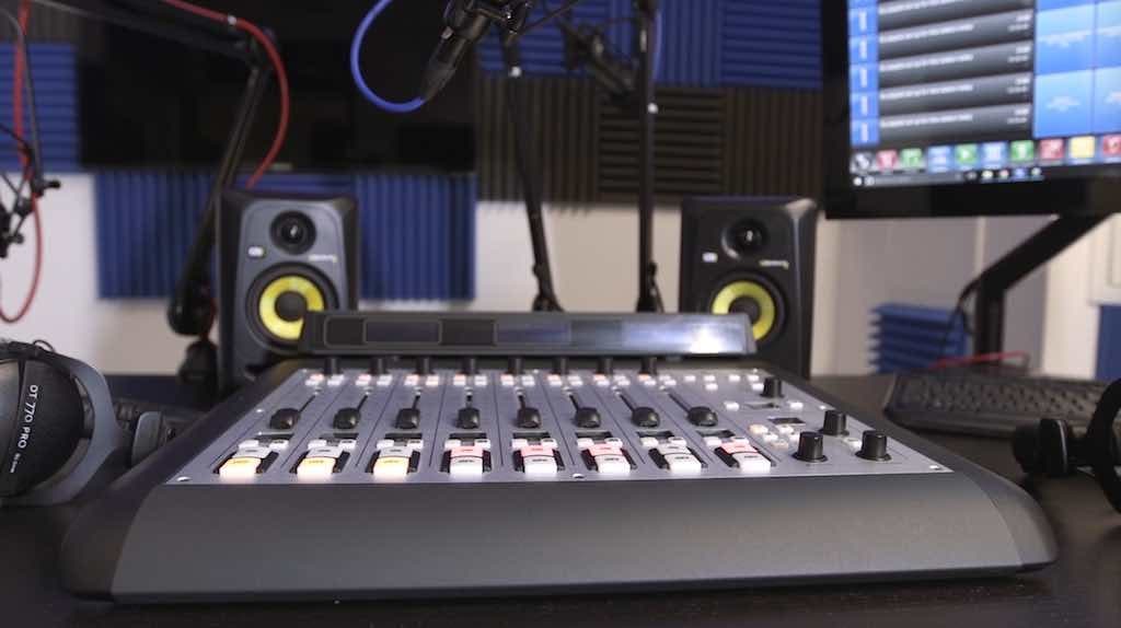 This is the Pro Studio Setup, a grey and black mixing desk, with black speakers visible in the back.