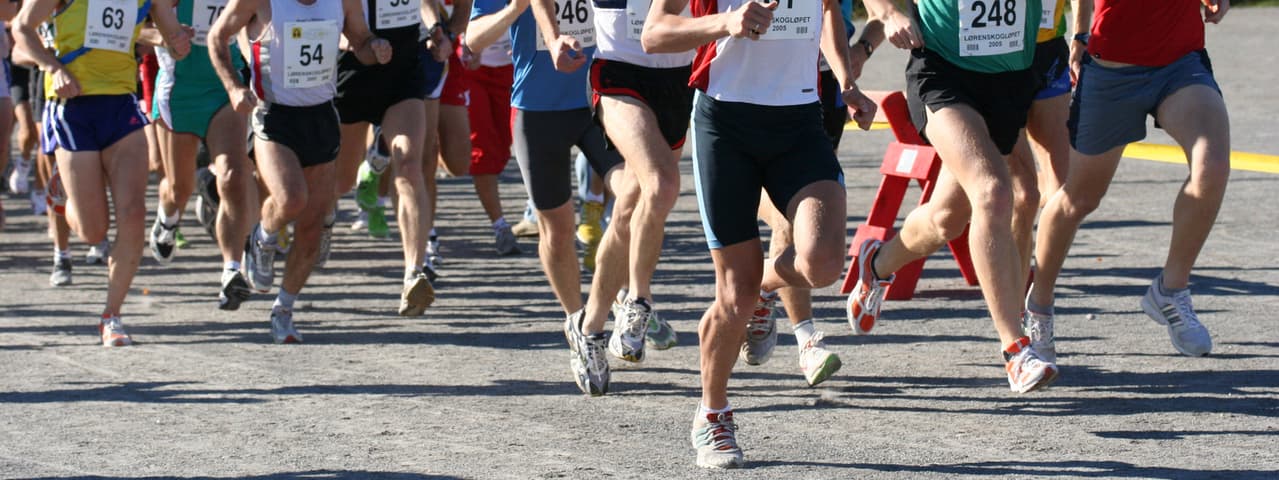 Marathon runners running along a road.
