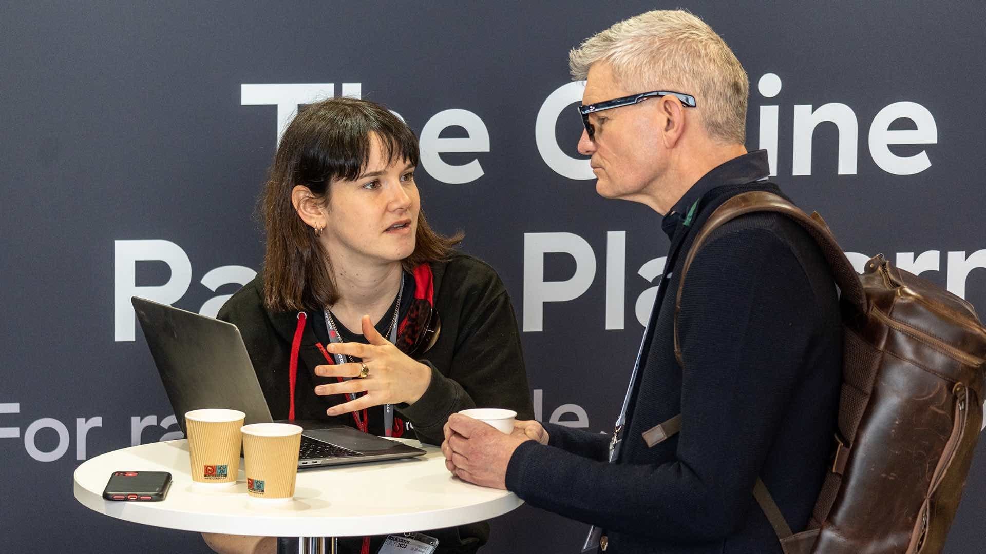 A Radio.co employee speaking to an attendee at Radiodays Europe 2023.