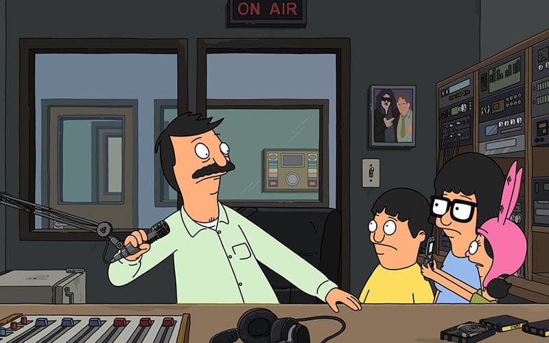 Image is a still from the TV Show Bob's Burgers, showing Bob, Jean , Tina and Louise in a radio studio.
