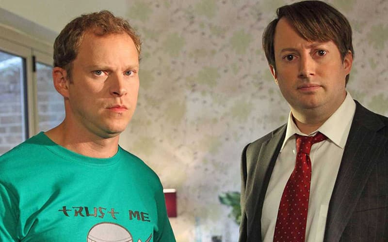Image shows the Peep Show characters Jez and Mark looking at the camera.