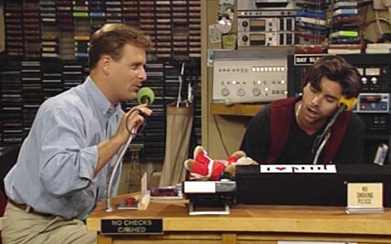 Image shows a still from the TV show Full House as the Joey and Jesse broadcast their Rush Hour Renegades show.