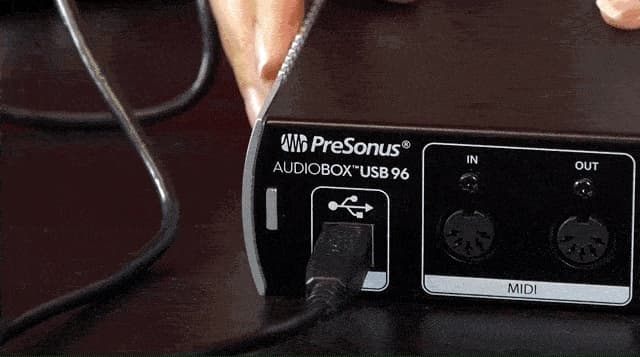 Image shows a USB cable plugged into an audio interface.