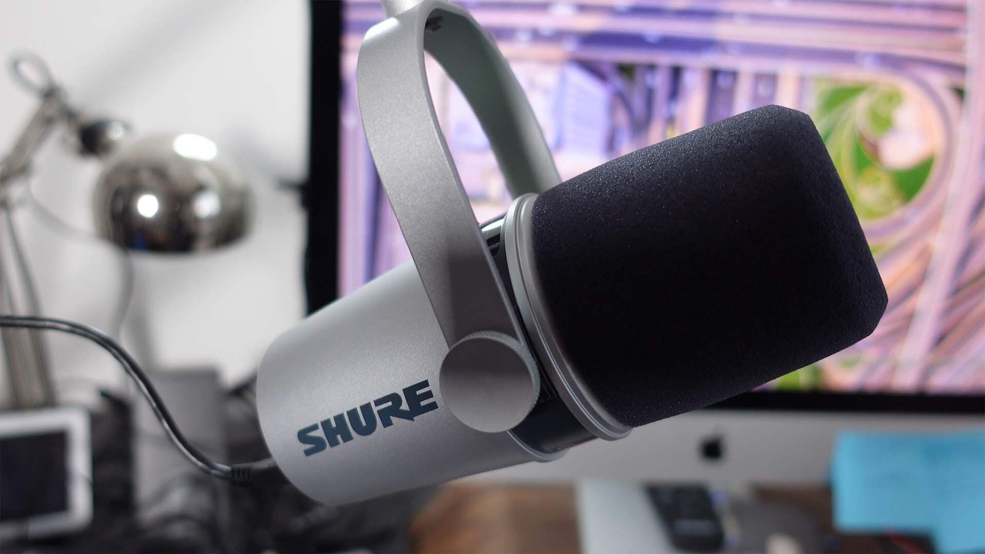 This is a silver and black Shure MV7 mic in front of a purple Mac screen.