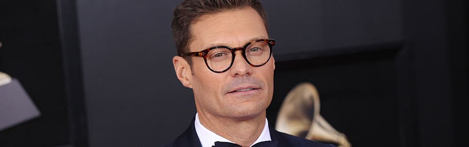 Image shows Ryan Seacrest at an awards ceremony.