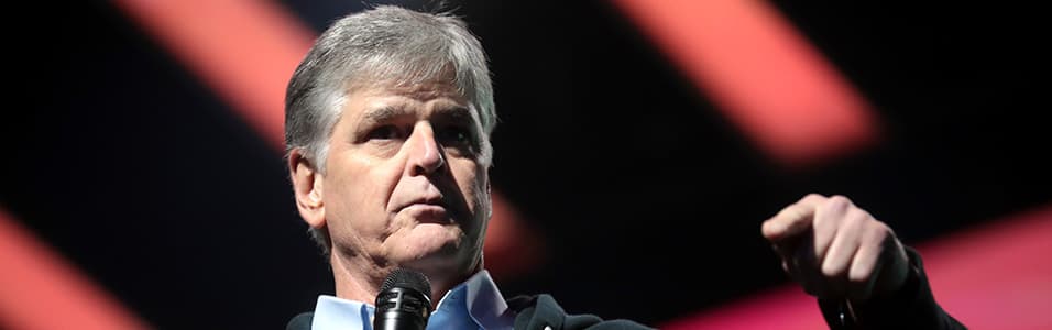 Image shows Sean Hannity on a stage.
