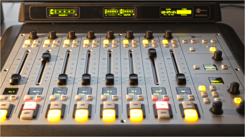 This is a silver and grey mixing desk with light green levels visible at the top of the image.