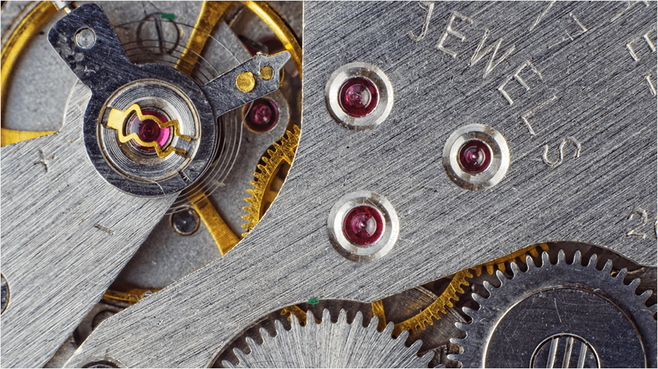 This is a zoomed in silver image of a wrench with different nuts and bolts visible.