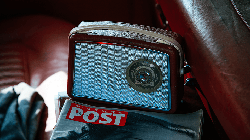 This is an image of a small portable radio over a magazine, seemingly the Daily Post.