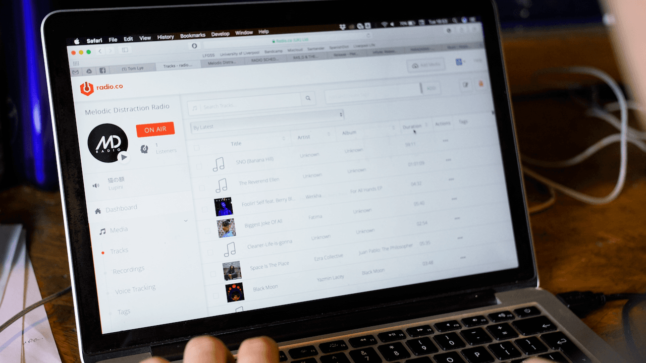 Image shows a laptop with Radio.co dashboard open on the screen.