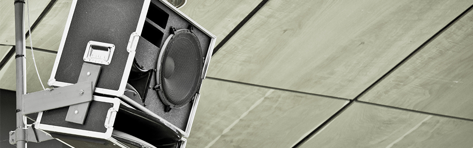This is a black and grey Mounted Speaker in the top left corner. The background is neutral and tiled.