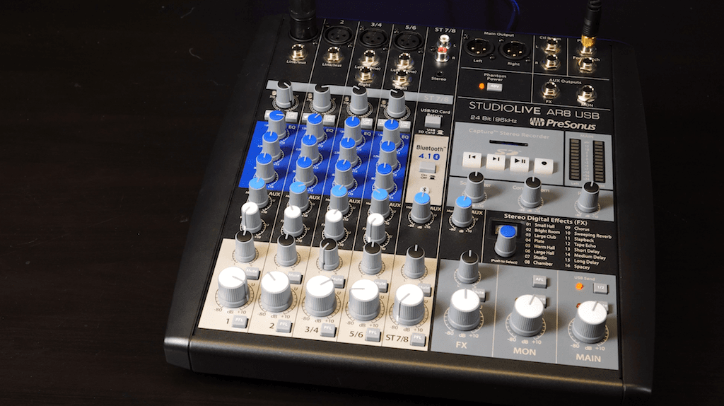 Image shows the PreSonus StudioLive AR8 USB Mixer on a black table.