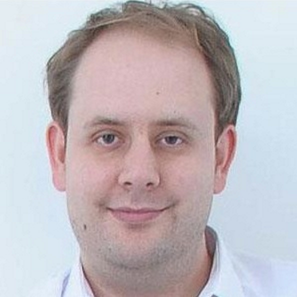 This is an image of Steve Benn. He is a white men with sandy coloured hair and brown eyes. He smiles at the camera. this is a head and shoulders shot.